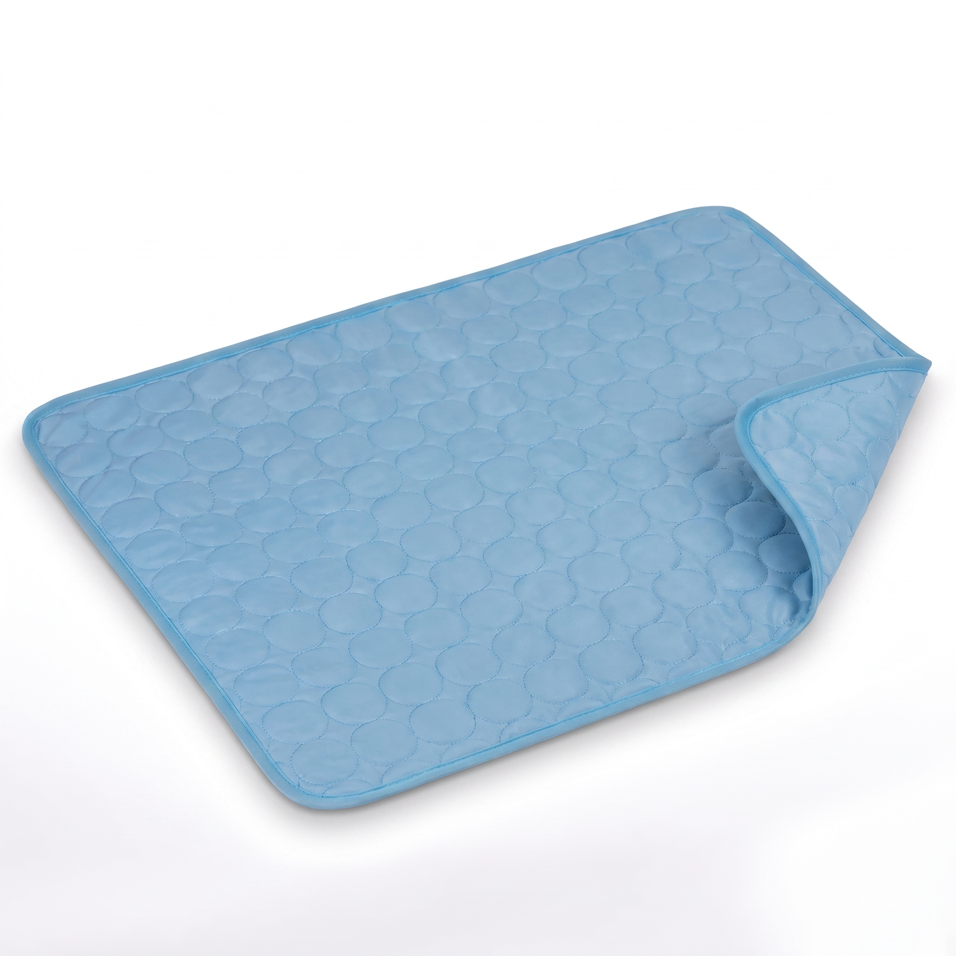Light blue quilted pet cooling mat with darker blue bound edge on a white background