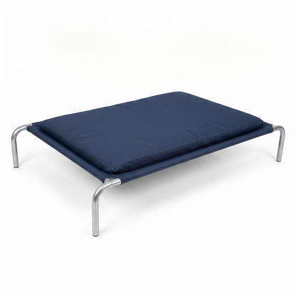 Raised dog bed with navy platform, padded cushion and silver metal legs on white background