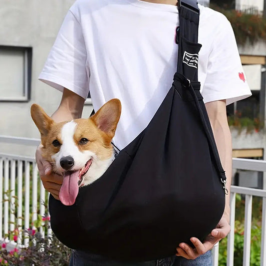 Corgi riding hands-free in the padded pet sling carrier