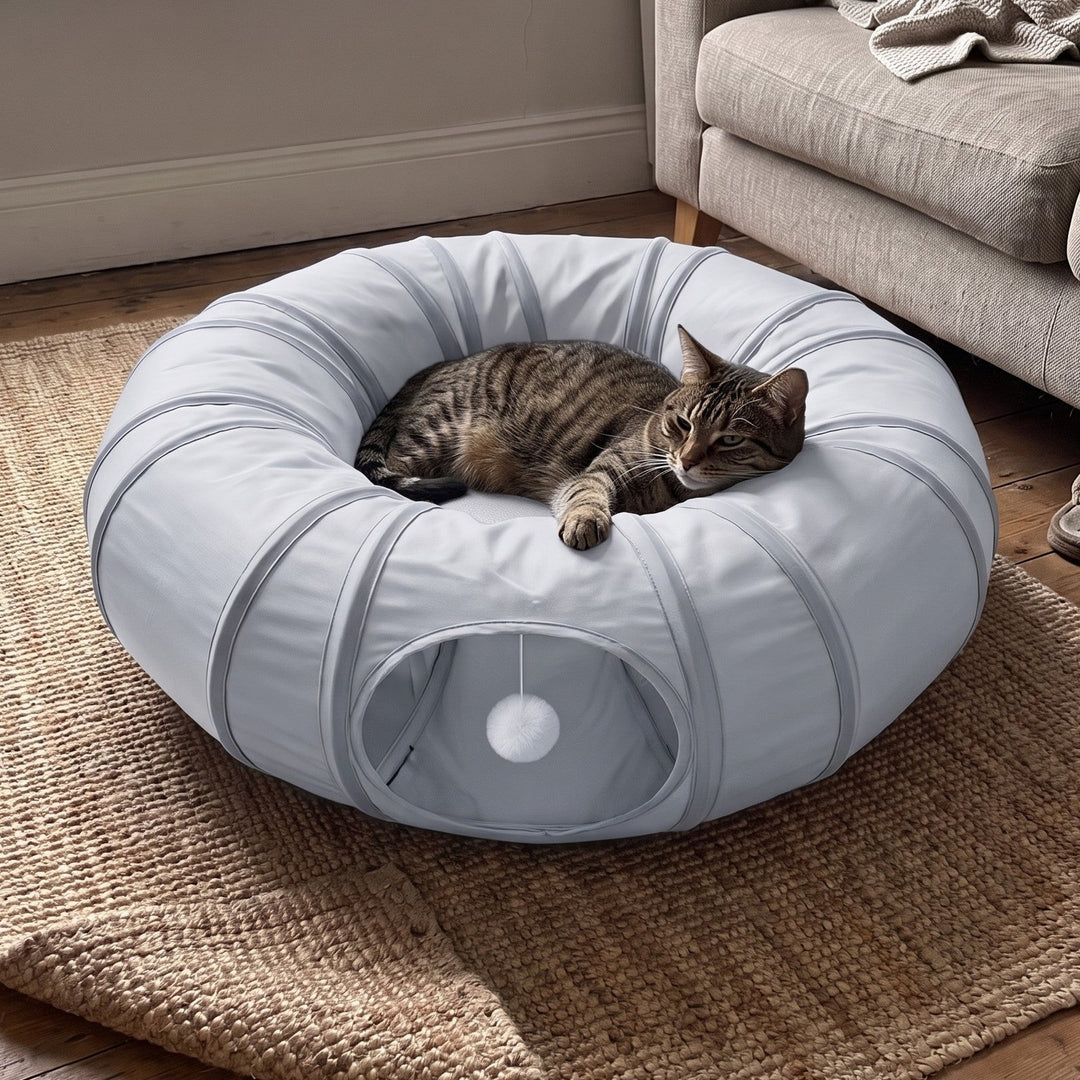 Cat tunnel bed in Ice Silk Grey with a tabby cat resting in the donut