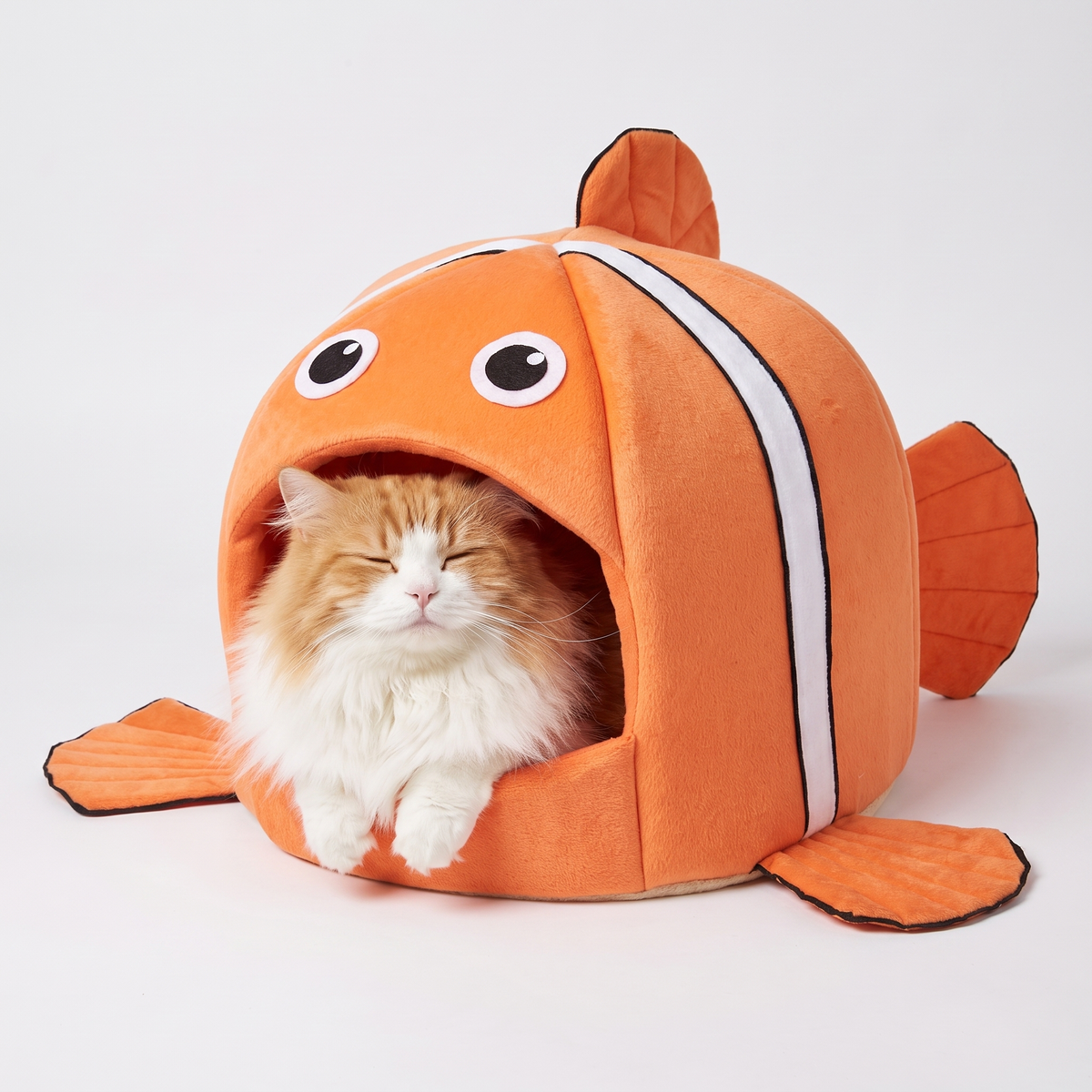 Fluffy cat nestled inside the clownfish cat cave bed