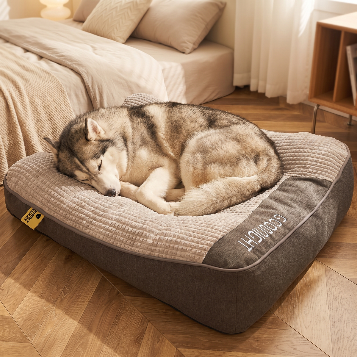 Husky asleep on the orthopedic dog sofa bed in a cosy bedroom