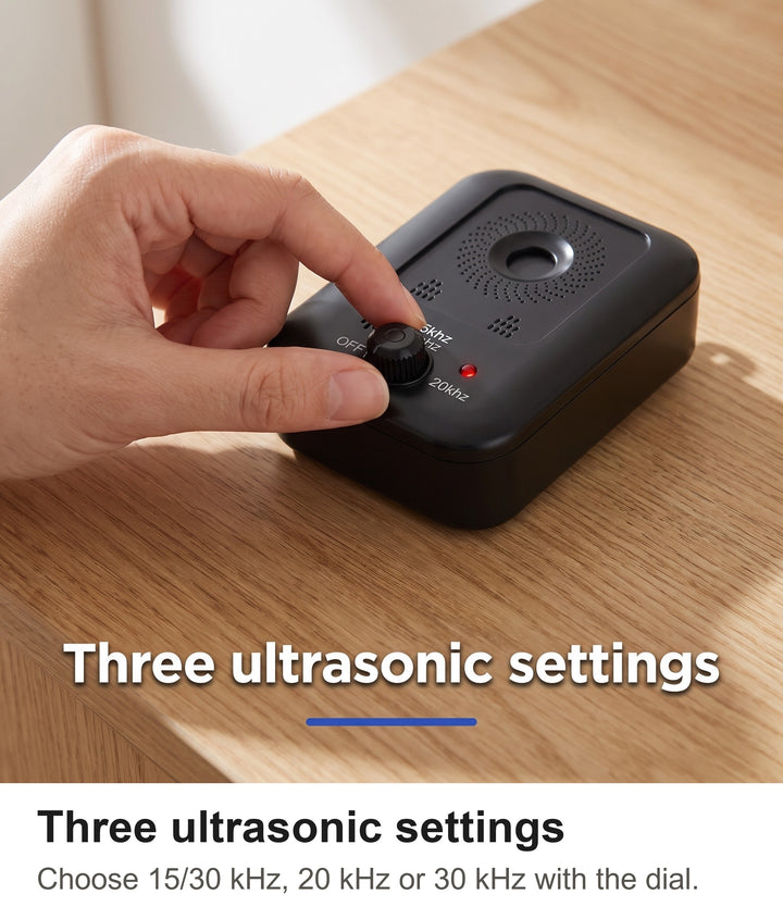 Fingers turning the mode dial on the ultrasonic dog barking deterrent