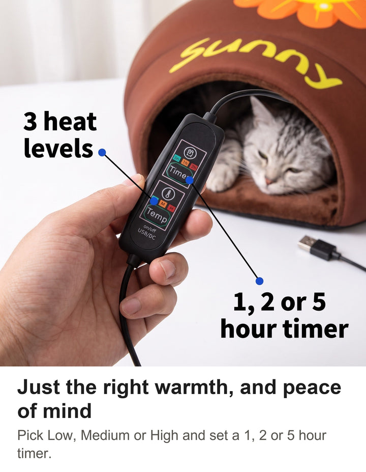 Hand holding the USB controller of the heated cat bed with its timer and temperature buttons