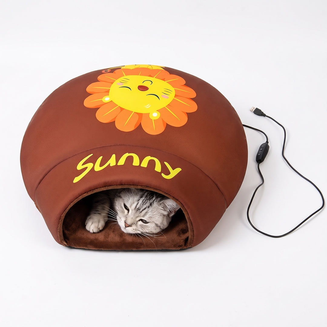 Silver tabby cat peeking out of a brown heated cat cave bed with USB cable