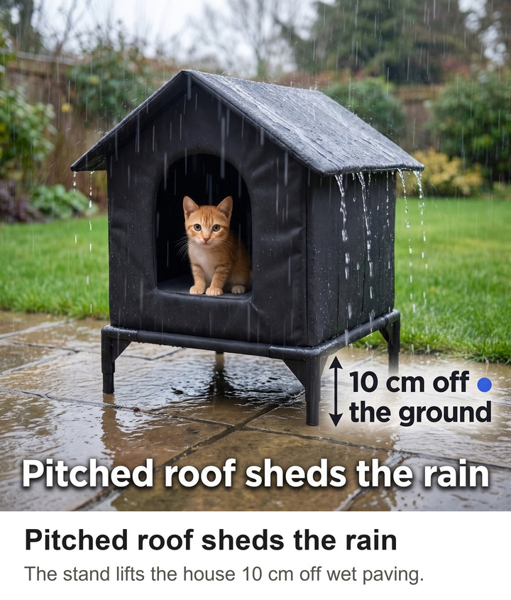 Black raised outdoor cat shelter on a wet patio in the rain with a cat inside