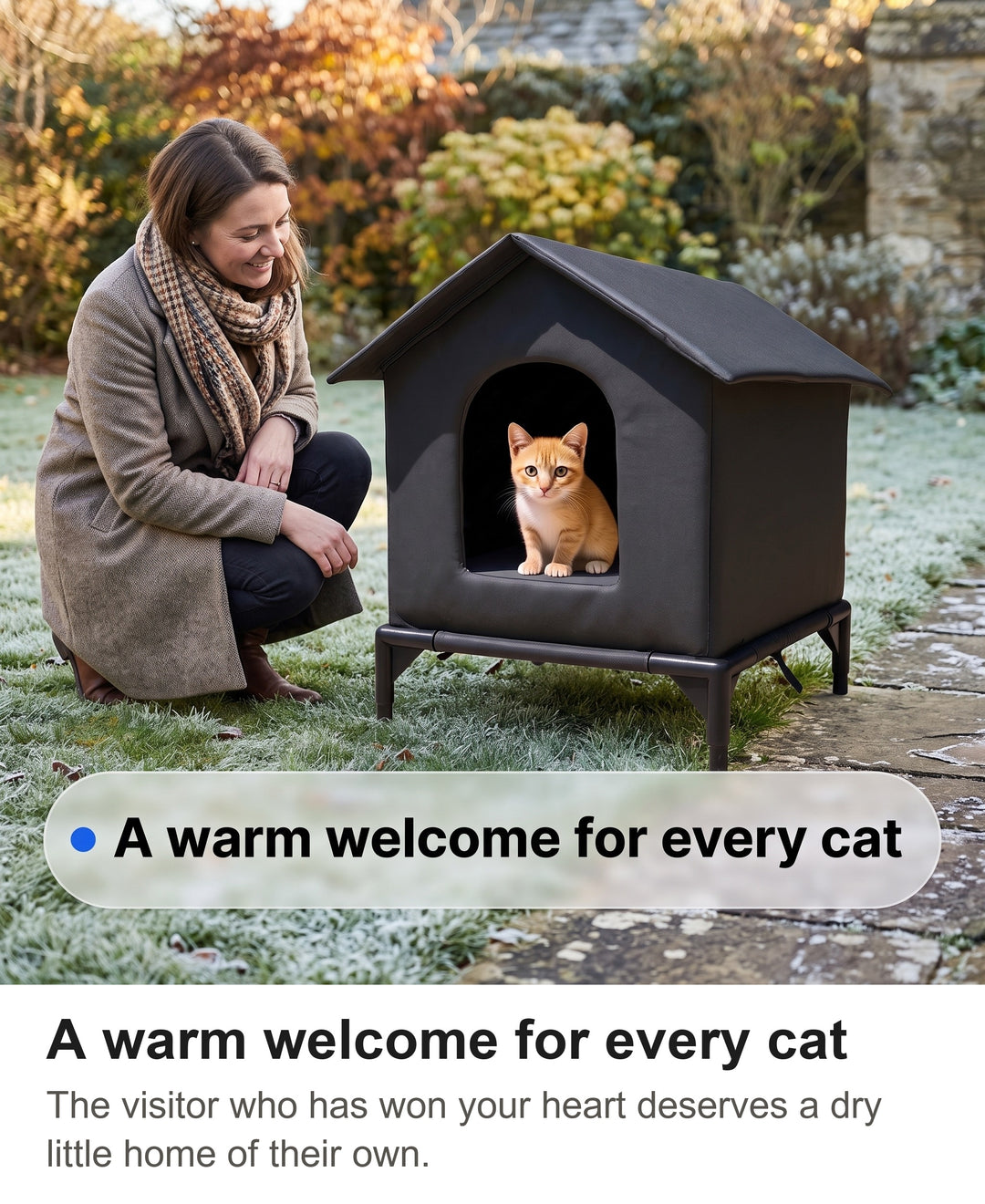Woman smiling at a ginger cat looking out of the black raised cat shelter in a garden