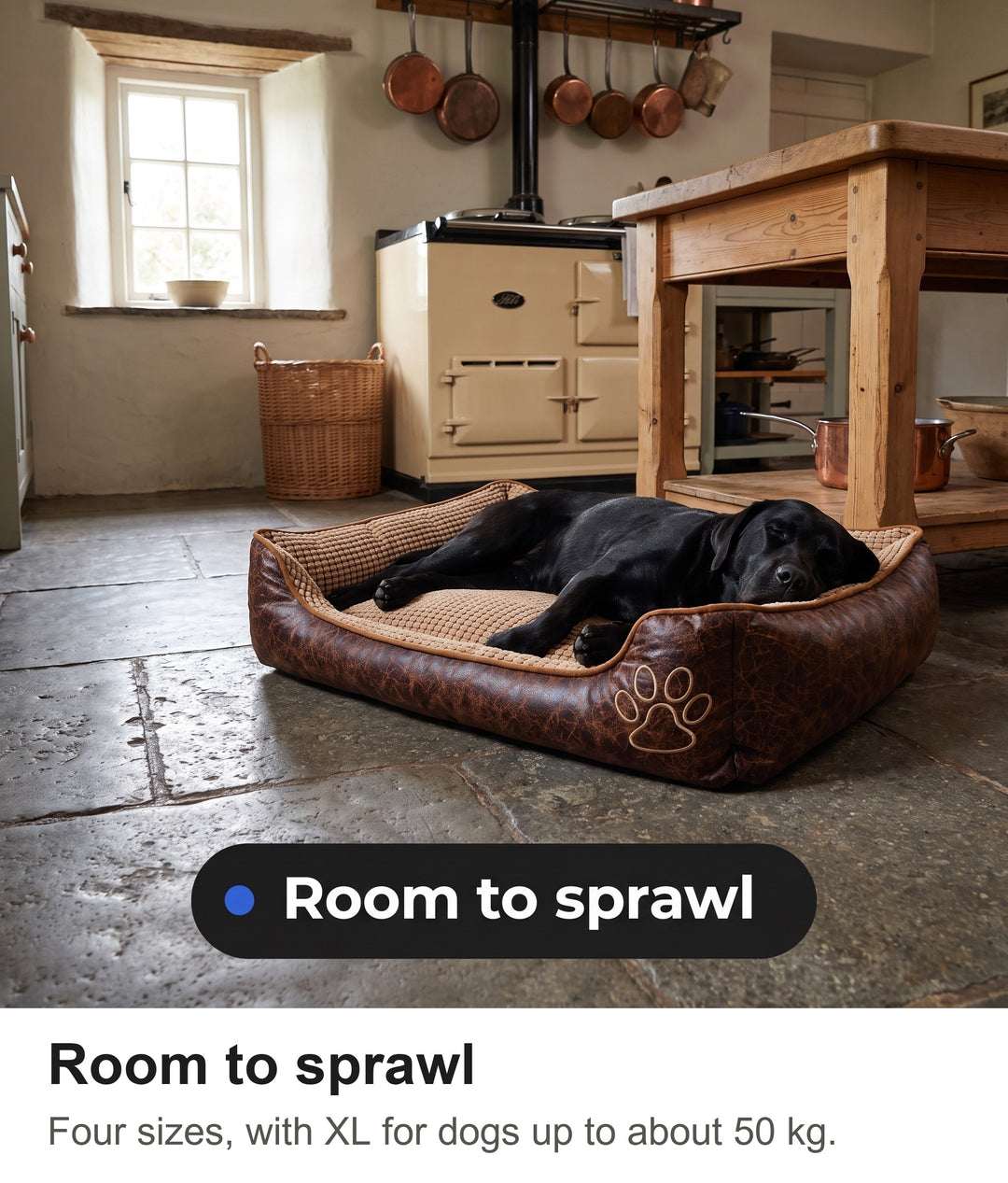 Black Labrador fast asleep in the large dog bed with sides on a farmhouse kitchen floor