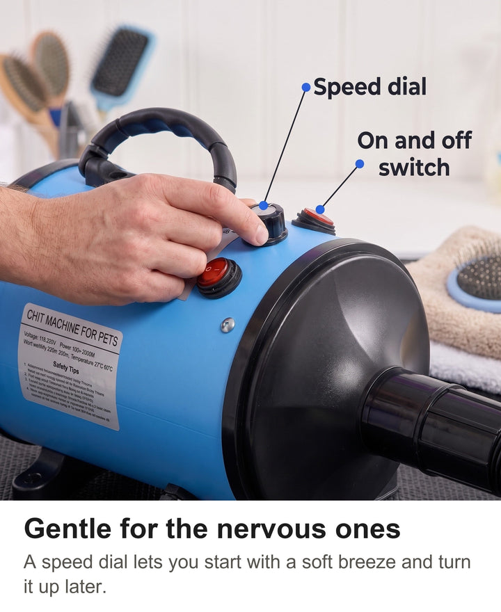 Hand turning the speed dial on top of the blue dog blow dryer