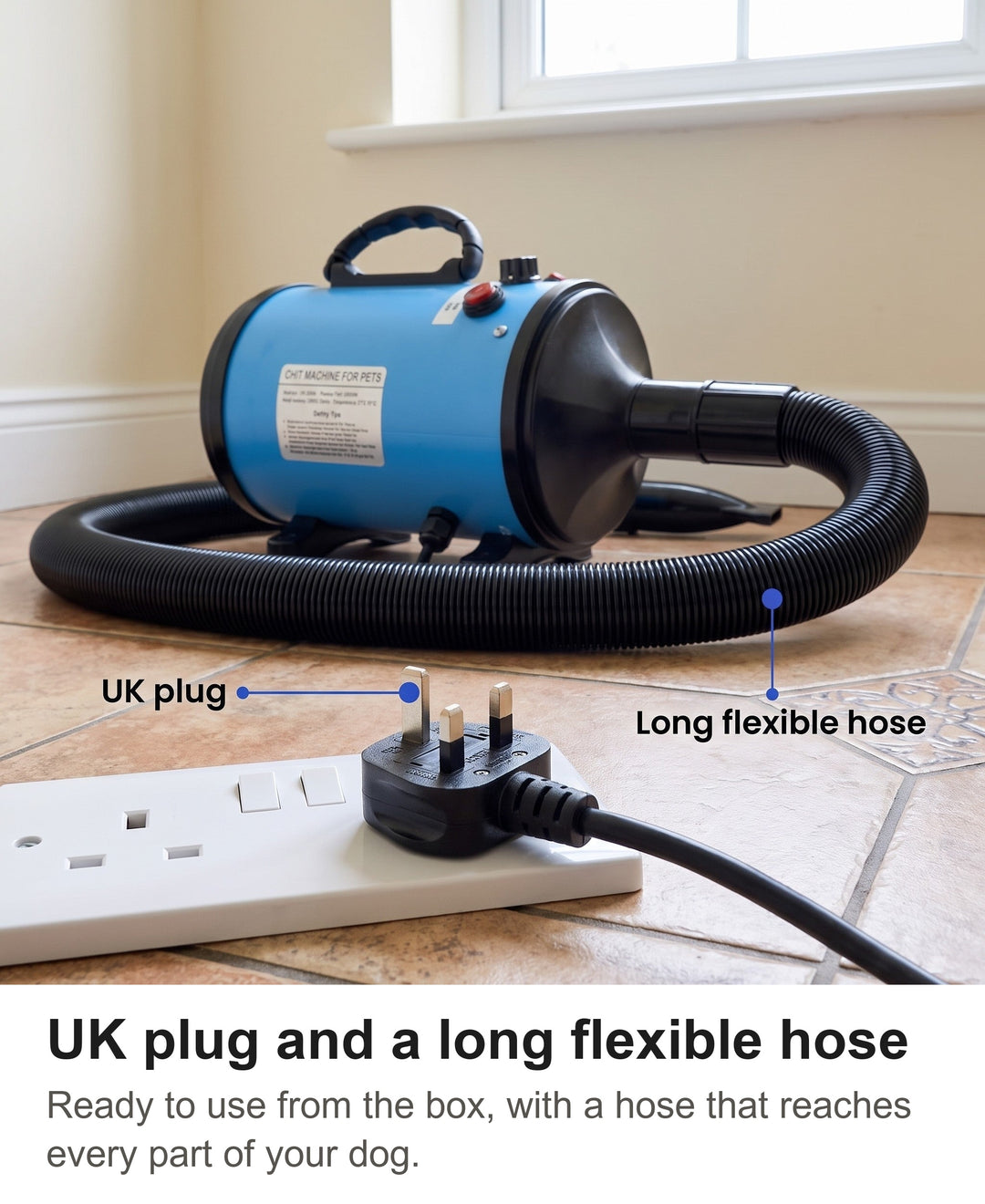 UK plug of the dog hair blower in a wall socket with the long flexible hose behind