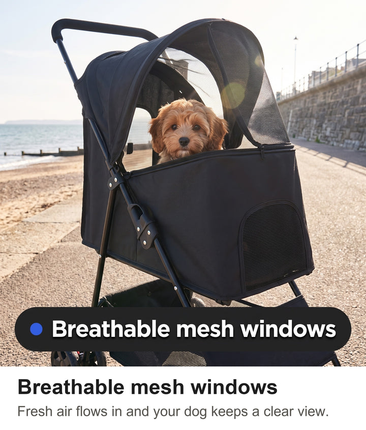 Small dog looking out from the dog stroller canopy with mesh windows