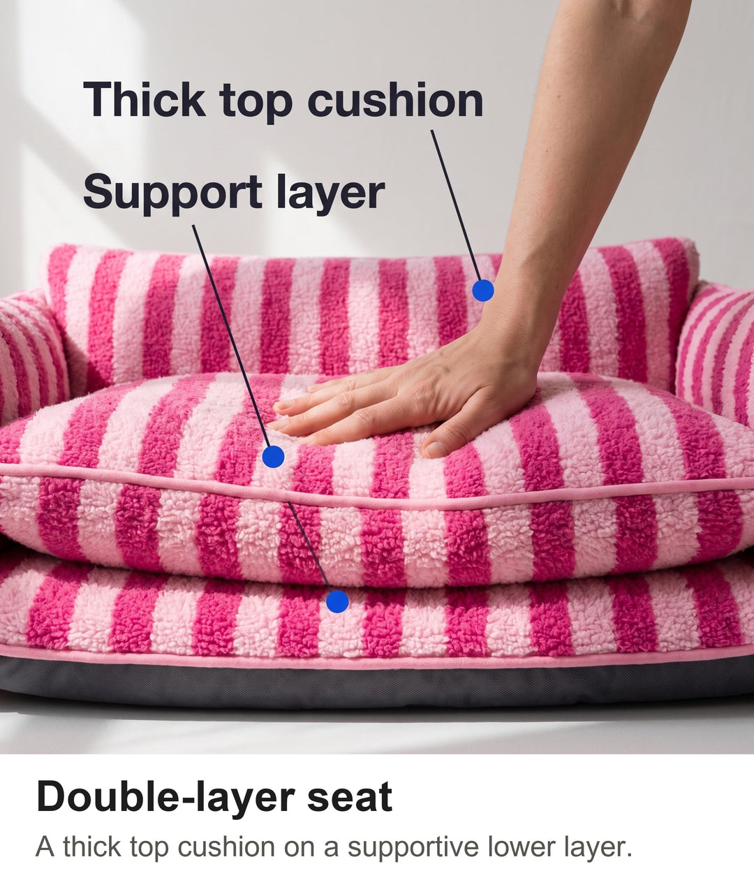 Hand pressing into the double-layer seat cushion of the striped dog couch bed