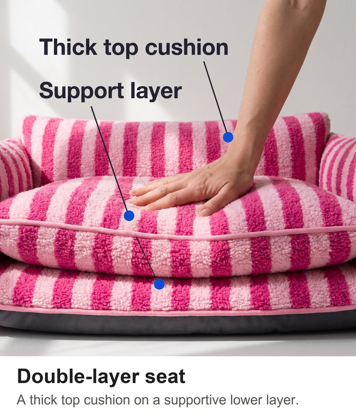 Hand pressing into the double-layer seat cushion of the striped dog couch bed