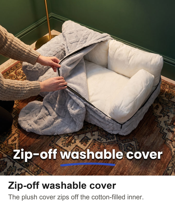 Hands removing the zip-off plush cover from the dog sofa bed to show the white inner