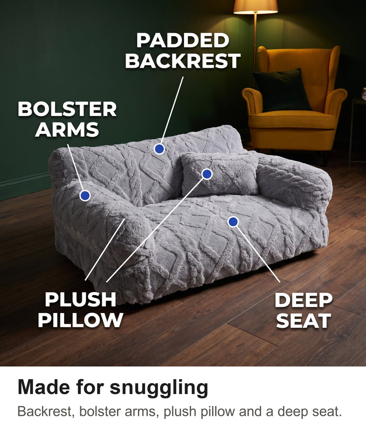 Dog couch bed with padded backrest, bolster arms, plush pillow and deep seat labelled