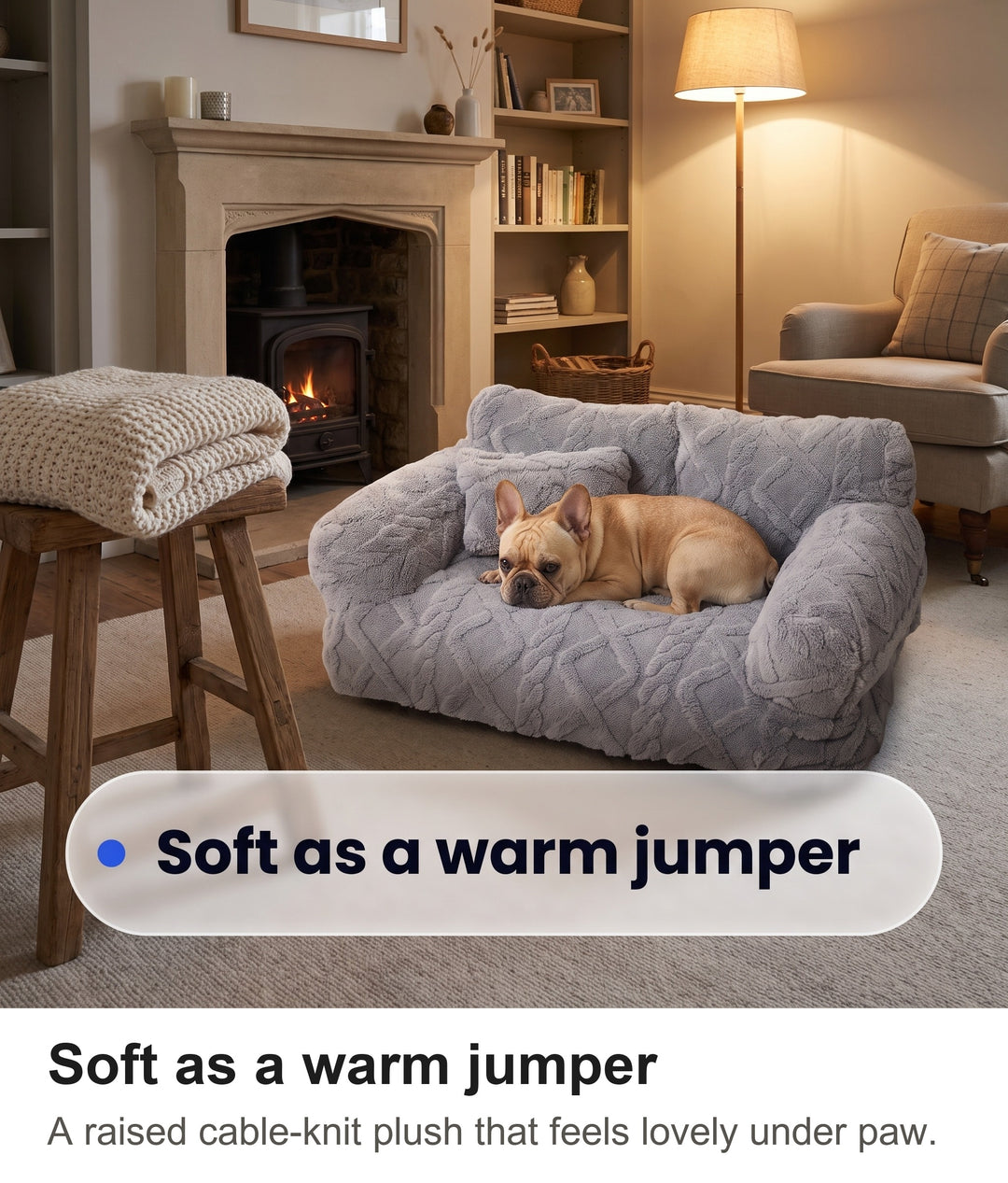 French bulldog resting on the cable-knit embossed plush of the light grey dog sofa bed beside a knitted blanket