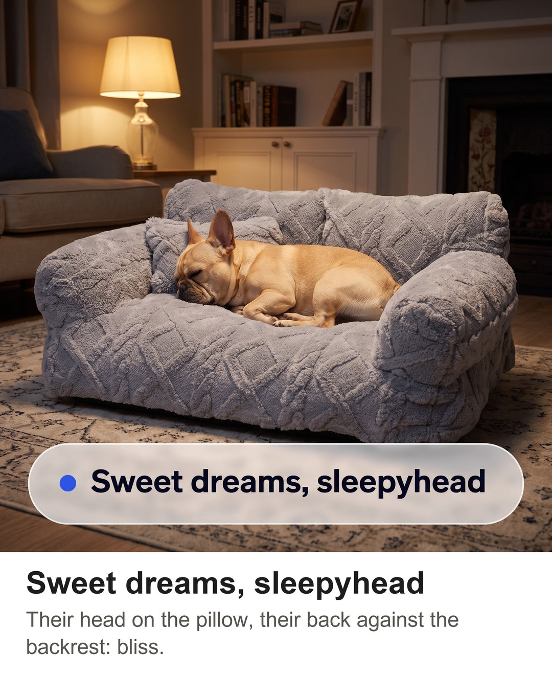 French bulldog asleep on the light grey dog sofa bed with its head on the pillow by lamp light