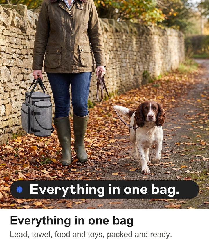 Woman carrying the grey dog walking bag on a countryside footpath with her springer spaniel
