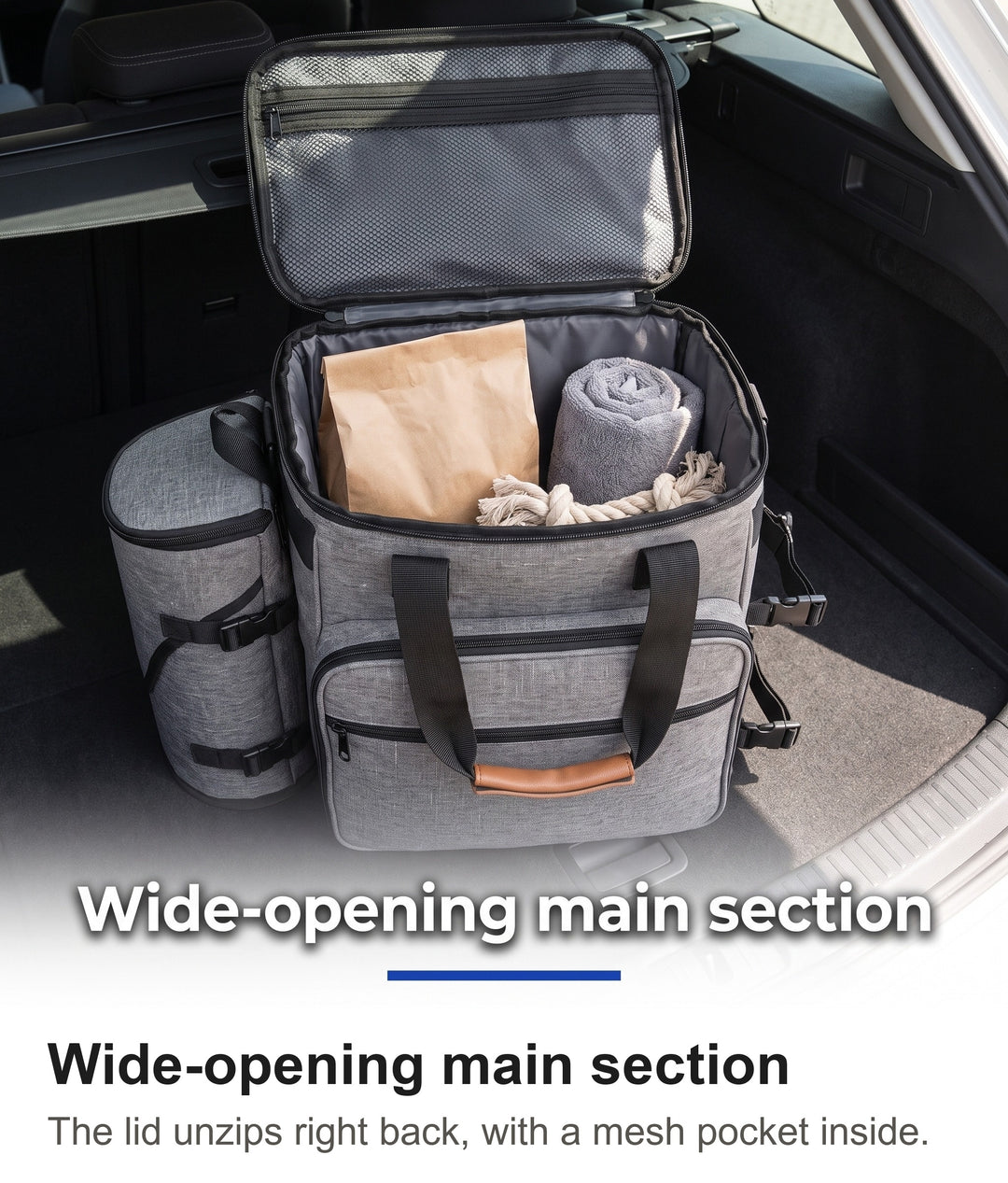 Grey dog travel bag open in a car boot showing the main compartment and mesh lid pocket