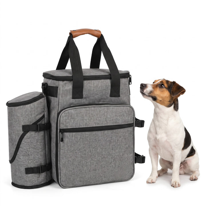 Grey dog travel bag with side food tube and leather-look handle, a Jack Russell sitting beside it