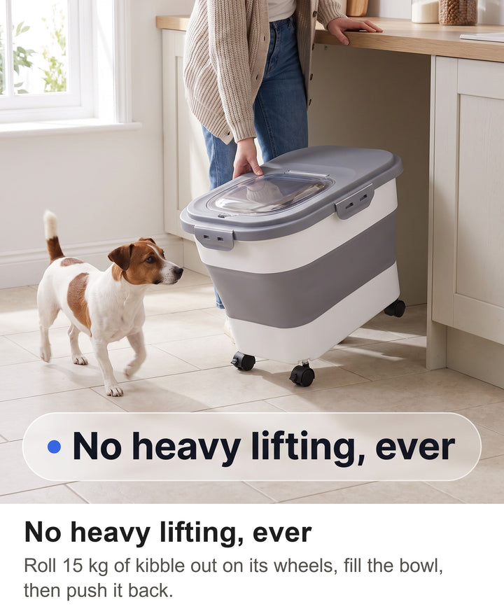 Woman rolling the food container on its wheels across a kitchen floor as a Jack Russell follows