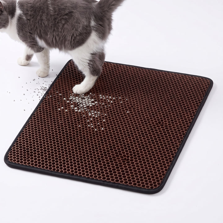 Brown double layer cat litter mat with a cat stepping off it