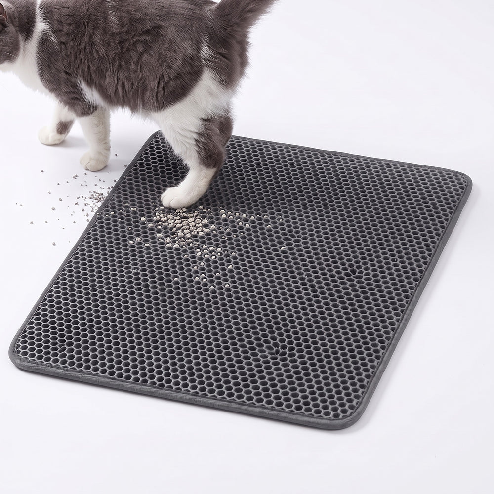 Grey double layer cat litter mat with a cat stepping off it