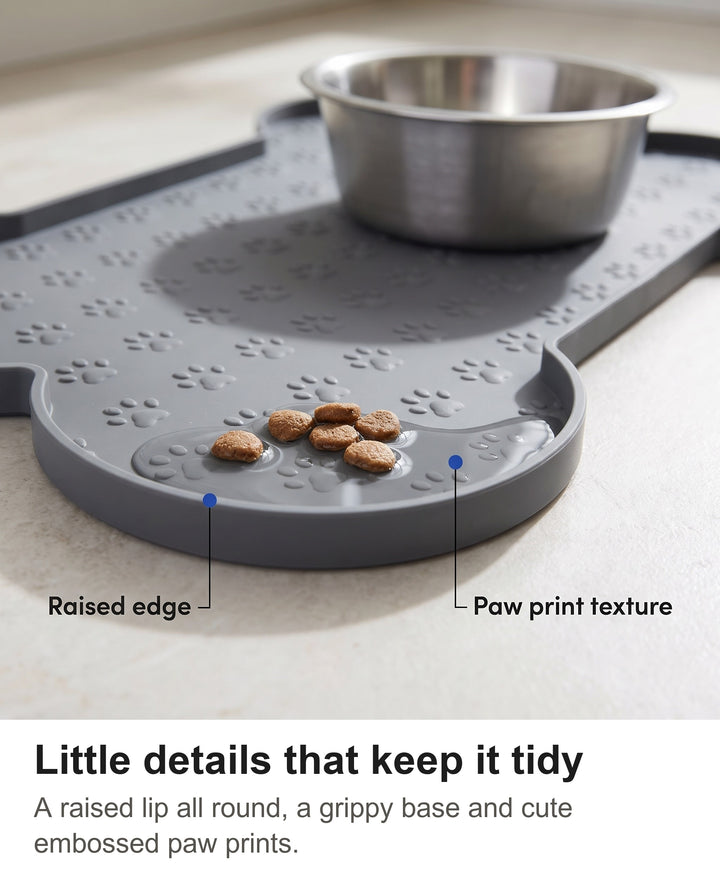Close-up of the raised edge and embossed paw prints on the grey silicone dog food mat