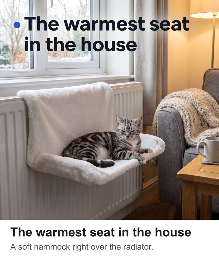 Silver tabby cat stretched out in the white plush cat radiator bed in a cosy living room